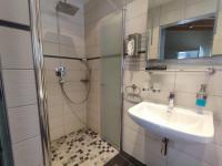 a bathroom with a sink and a shower at Gästehaus im Alten Fährhaus in Cochem