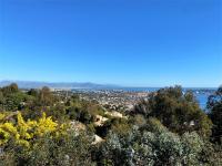 a view of a city from the top of a hill at VILLA LE MAS D&#39;AZUR BY ESTATESCANNES in Vallauris