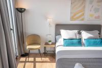 Postel nebo postele na pokoji v ubytování Feelathome Stadium Apartments
