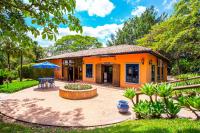 a small orange house with a patio and a table at Itu Garden - SPA e Resort Saudavel in Itu