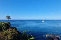 a view of a large body of water with a boat at Superbe appartement vue mer - résidence de standing in Schœlcher