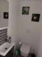 a bathroom with a white toilet and a sink at Superbe appartement vue mer - résidence de standing in Schœlcher