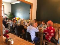 a group of people sitting at tables in a restaurant at Namibia Nights Accommodation in Swakopmund
