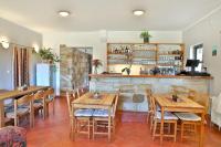 a restaurant with wooden tables and chairs and a bar at MÍSTO na Klokočských skalách - Penzion Kairos in Klokočí