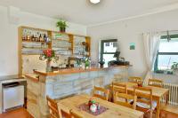 a kitchen and dining room with tables and a bar at MÍSTO na Klokočských skalách - Penzion Kairos in Klokočí