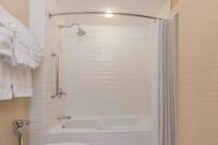 a bathroom with a shower and a white tub at The Raphael Hotel, Autograph Collection in Kansas City