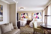 a hotel room with two beds and a desk at The Raphael Hotel, Autograph Collection in Kansas City