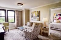 a living room with a couch and a bed at The Raphael Hotel, Autograph Collection in Kansas City