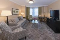 a living room with a couch and a tv at The Raphael Hotel, Autograph Collection in Kansas City