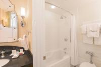 a bathroom with a tub and a toilet and a sink at The Raphael Hotel, Autograph Collection in Kansas City