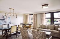 a living room with a table and a dining room at The Raphael Hotel, Autograph Collection in Kansas City