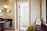 a bathroom with a sink and a mirror at The Raphael Hotel, Autograph Collection in Kansas City