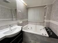 a bathroom with a sink and a bath tub at Guide Hotel Taipei Xinyi in Taipei