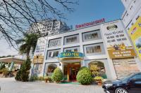 a large white building with a snowman sign on it at Sao Mai Hotel in Thanh Hóa