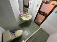 a bathroom with a toilet and a sink at Boston Hotel in Chiayi City