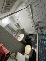 a bathroom with a toilet and a sink and a mirror at Boston Hotel in Chiayi City