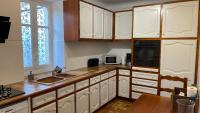 a kitchen with white cabinets and a sink and a window at Appartement d&#39;époque avec jardin et parking 4 personnes Le Port de Nice in Nice