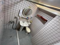 a bathroom with a sink and a mirror at Boston Hotel in Chiayi City