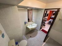a bathroom with a sink and a toilet at Boston Hotel in Chiayi City