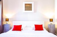 a bedroom with a white bed with red pillows at Sainte Catherine - Duplex 1 chambre in Bordeaux