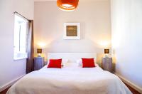a bedroom with a large white bed with red pillows at Sainte Catherine - Duplex 1 chambre in Bordeaux