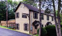 a house with a sign that reads take a run at Slide Mountain Forest House in Oliverea
