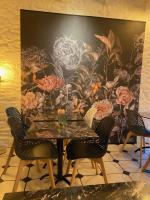 ein Esszimmer mit einem großen floralen Wandbild in der Unterkunft Manoir De Rigourdaine in Plouër-sur-Rance