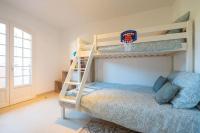 a bedroom with two bunk beds and a basketball sign at Les Jardins de Provence • Beau Rivage • Proche mer in Carqueiranne