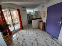 a kitchen with a floor that is covered in marble at Le Studio de Jo in Cayenne