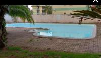 a large blue swimming pool in a yard at Le Studio de Jo in Cayenne