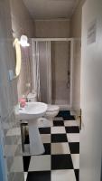 a bathroom with a white sink and a toilet at Pensión San Benito Abad in Seville