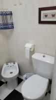 a bathroom with a white toilet and a sink at Pensión San Benito Abad in Seville