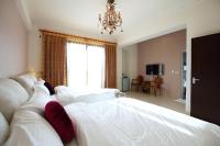 a large bedroom with two beds and a chandelier at Dear B&amp;B in Hualien City