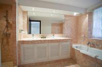 a bathroom with two sinks and a tub and a mirror at Saint-Vincent in Saint-Tropez