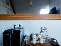 a wooden shelf with cups and a coffee maker on it at Chambres d&#39;hôtes chez l&#39;habitant - Bed&amp; Breakfast homestay in Huisnes-sur-Mer