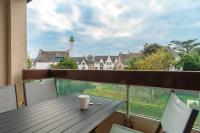 a table on a balcony with a cup of coffee at Ty Menez - Proche plage pour 4 in Bénodet