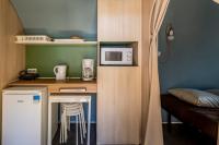 a small kitchen with a counter and a microwave at Les Insolites du vélodrome d&#39;Albert in Albert