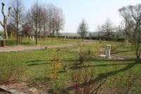 a park with a fence and a field with trees at Les Insolites du vélodrome d&#39;Albert in Albert