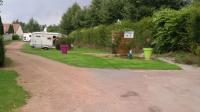 a dirt road next to a campsite with a trailer at Les Insolites du vélodrome d&#39;Albert in Albert