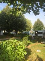 a group of vehicles parked in a yard with trees at Les Insolites du vélodrome d&#39;Albert in Albert