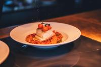 un plato blanco de comida en una mesa en Slottsholmen Hotell och Restaurang, en Västervik