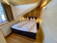 A bed or beds in a room at Alpenapart Singer - contactless check-in