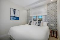 A bed or beds in a room at New & Beautiful Apt walk to the beach - RDR251