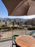 a patio with a table and chairs and an umbrella at Auberge Les Grillons in Meyras