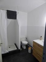 a white bathroom with a toilet and a sink at Auberge Les Grillons in Meyras