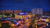 a city lit up at night with buildings at The Cove - Condo Hotel - Palm Beach Strip in Palm-Eagle Beach