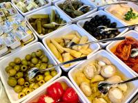 a bunch of trays filled with different types of food at Bergdorf Hotel Zaglgut in Kaprun