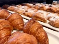 a bunch of croissants and other pastries on trays at Bergdorf Hotel Zaglgut in Kaprun