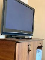 a flat screen tv sitting on top of a cabinet at Hotel Nalba Jupiter in Jupiter