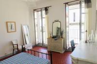 a bedroom with a bed and a dresser with a mirror at Tout le charme de l&#39;ancien marseillais in Marseille